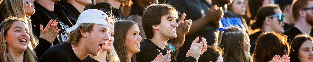 Students cheering at football game